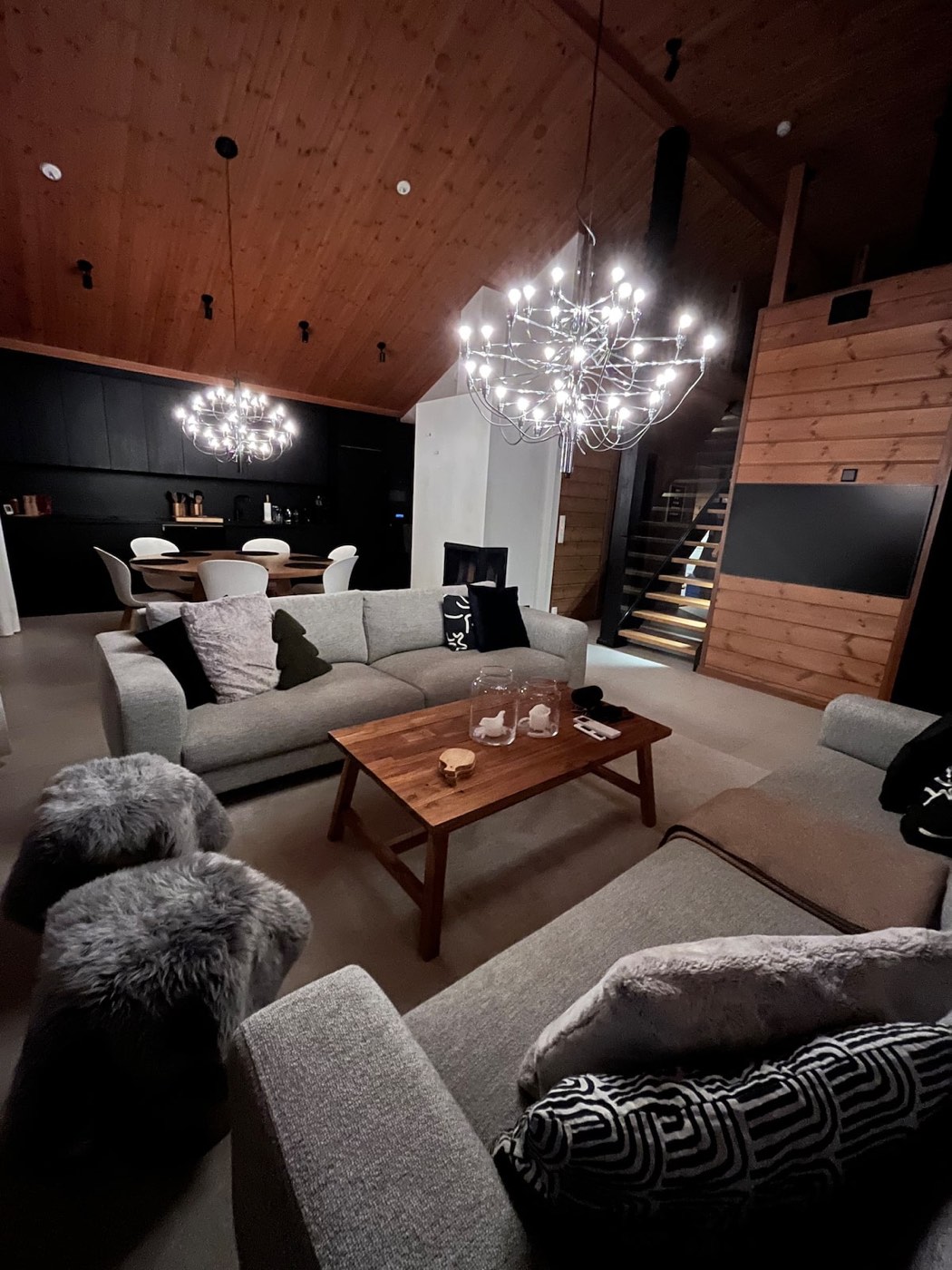 Living room in the evening with chandeliers lit