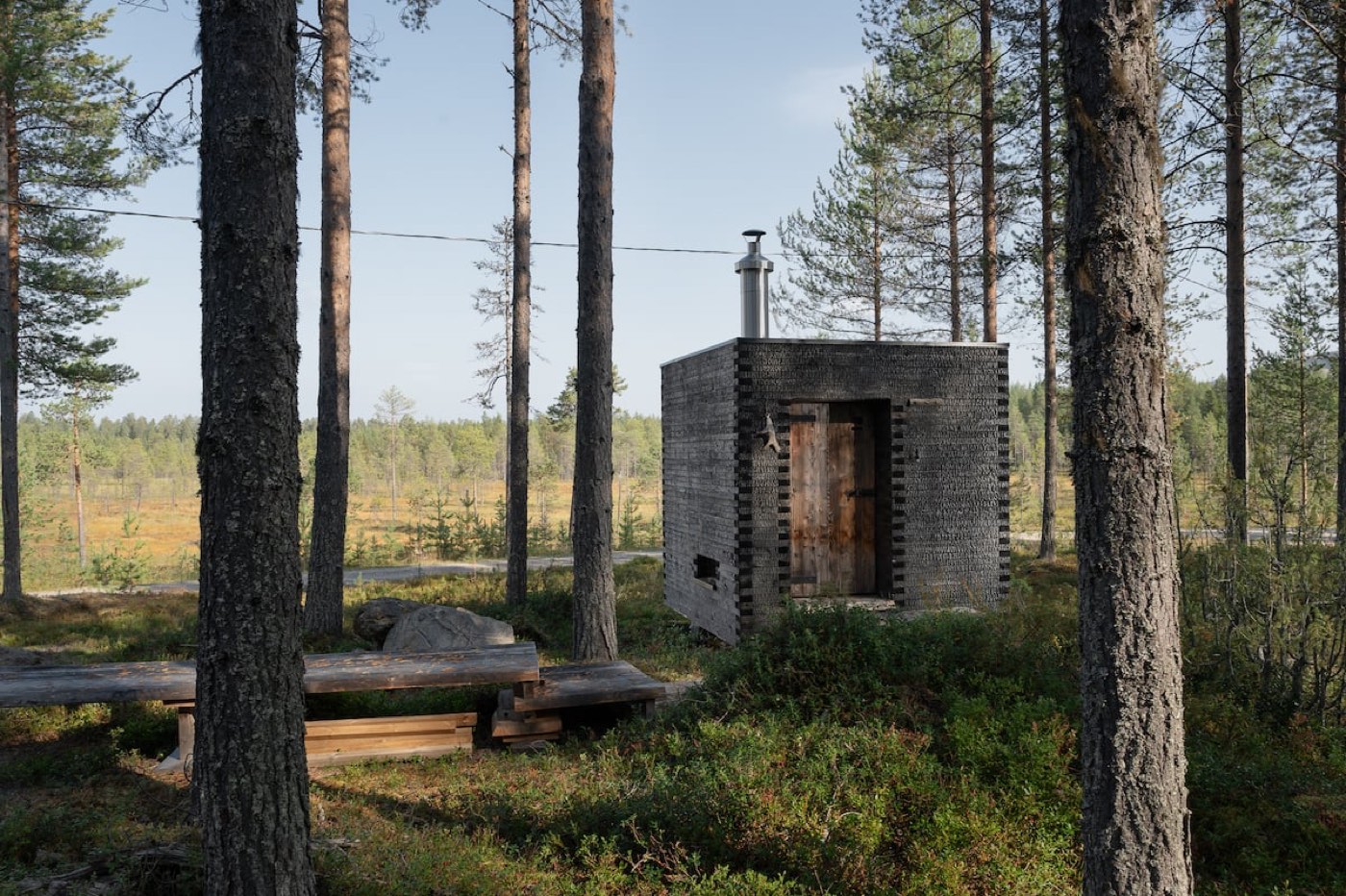The wood-burning sauna at the edge of the open marsh on a summer evening